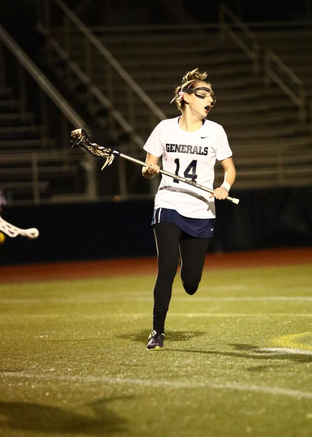 Sophomore Emma Vogel runs across the field during a W-L Varsity Lacrosse game.