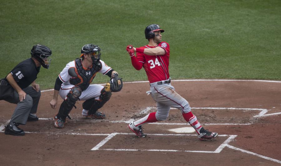 Bryce Harper at home plate, getting ready to swing.