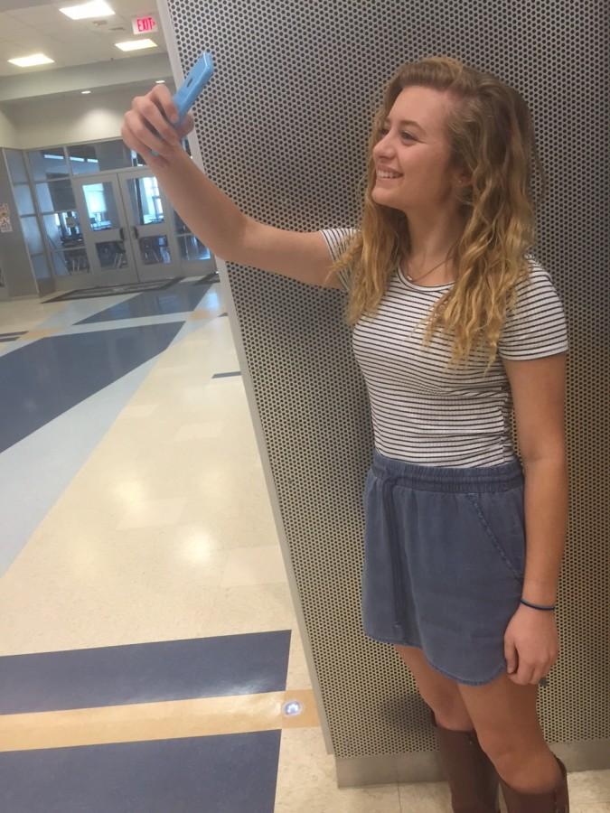 Junior Carolyn Bradley uses her iPhone to take a selfie and post it on her Snapchat story