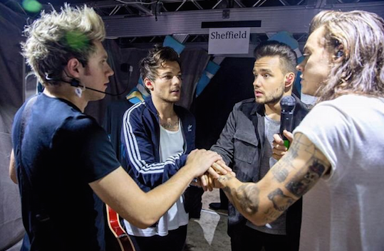 The boys of One Direction huddle for some final words of encouragement before they head on stage.