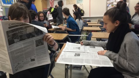 Junior Grace Leckey and senior Rachel Carlson read the Crossed Sabres in class. 