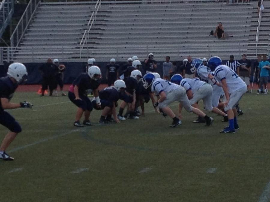 The JV team at a game. Evelyn Smith is the player with the pink shirt beneath her jersey.