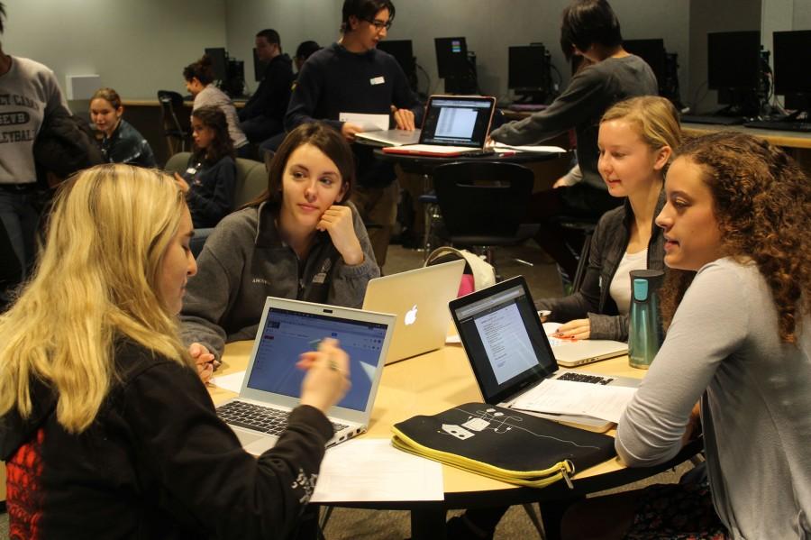 Senior Sally Ancheva and juniors Caroline Freeman, Anna Polise, and Maggie Harris brainstorm which school issue their group wishes to address. 