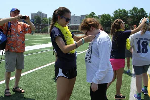 Best Buddies President senior Sally Ancheva awards sophomore Abigail Hall after events for the day concluded. 