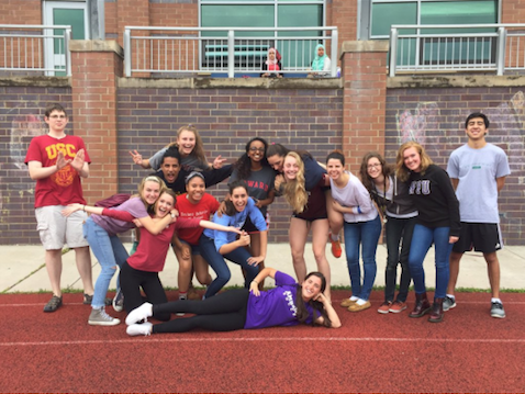 A group of seniors pose to represent their respective college choices.