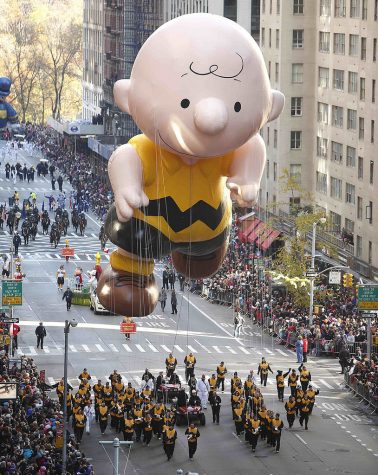 A Charlie Brown float hovers over Macy’s Thanksgiving Day Parade onlookers in New York, New York in 2012. Charlie Brown has become one of the few faces of Thanksgiving due to A Charlie Brown Thanksgiving.