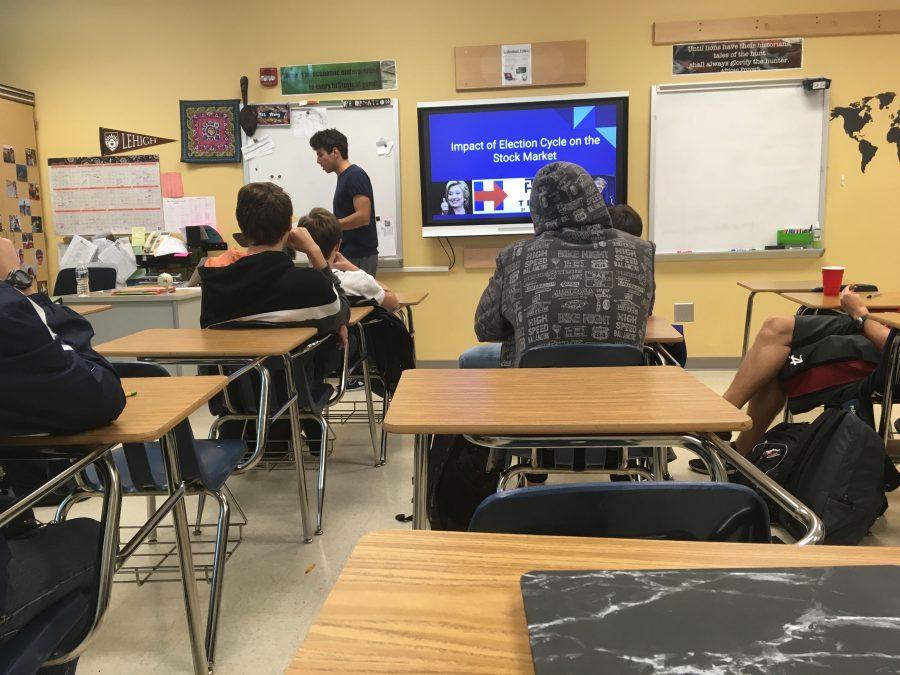 Ricardo Mestre gives a presentation on how the presidential election affected the stock market.