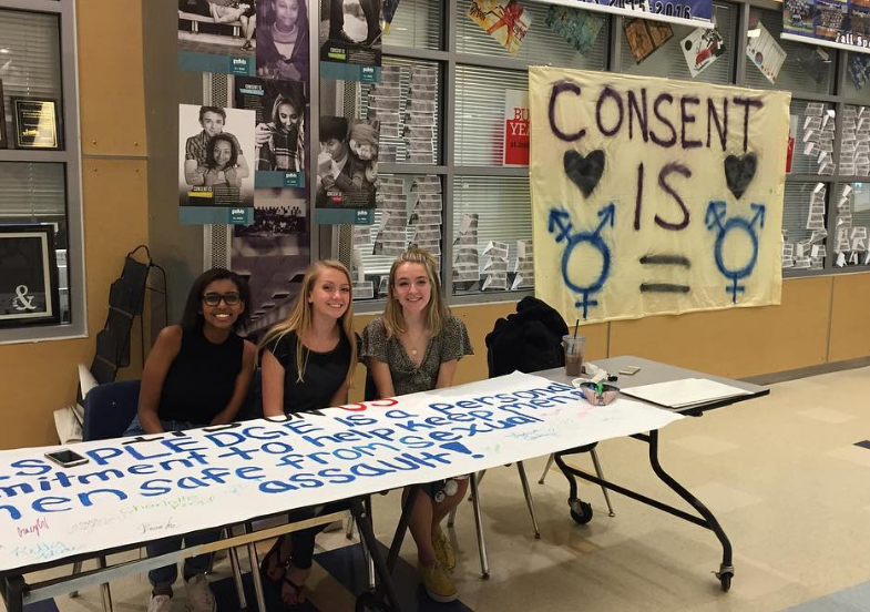 Members of the Healthy Relationship Task Force sit at their Consent is... campaign booth during lunches last school year.