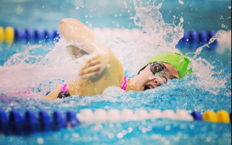Senior Ellie Ridgeway swims freestyle at an AAC swim meet in 2015. 