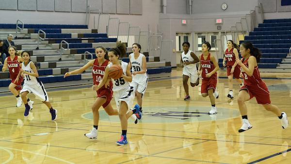 Sophomore Alexis Parks runs down the court as she attempts to guard the ball from a McLean player. 