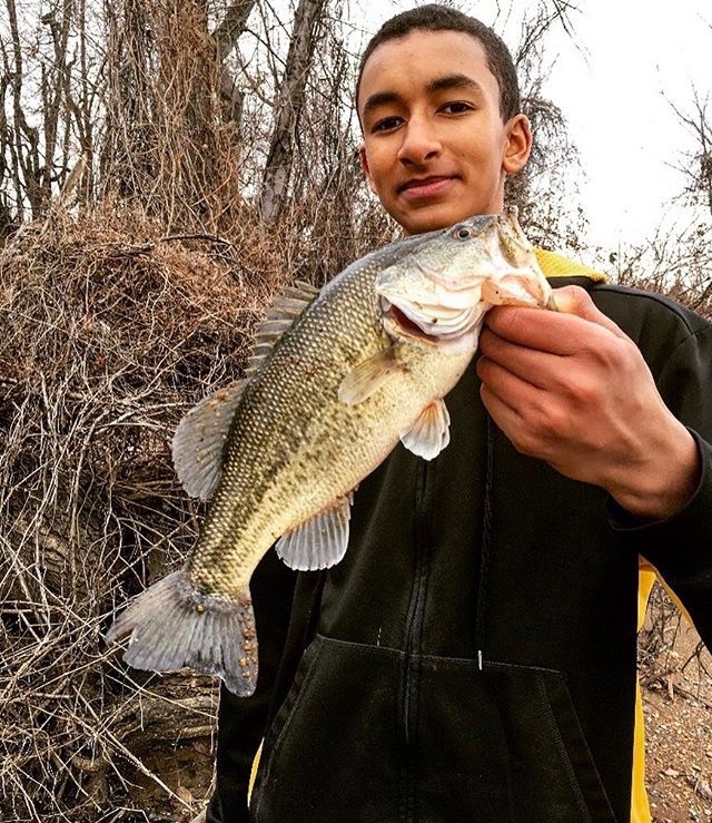Sophomore Adam Carter catches a largemouth bass in a pond near National Airport.
