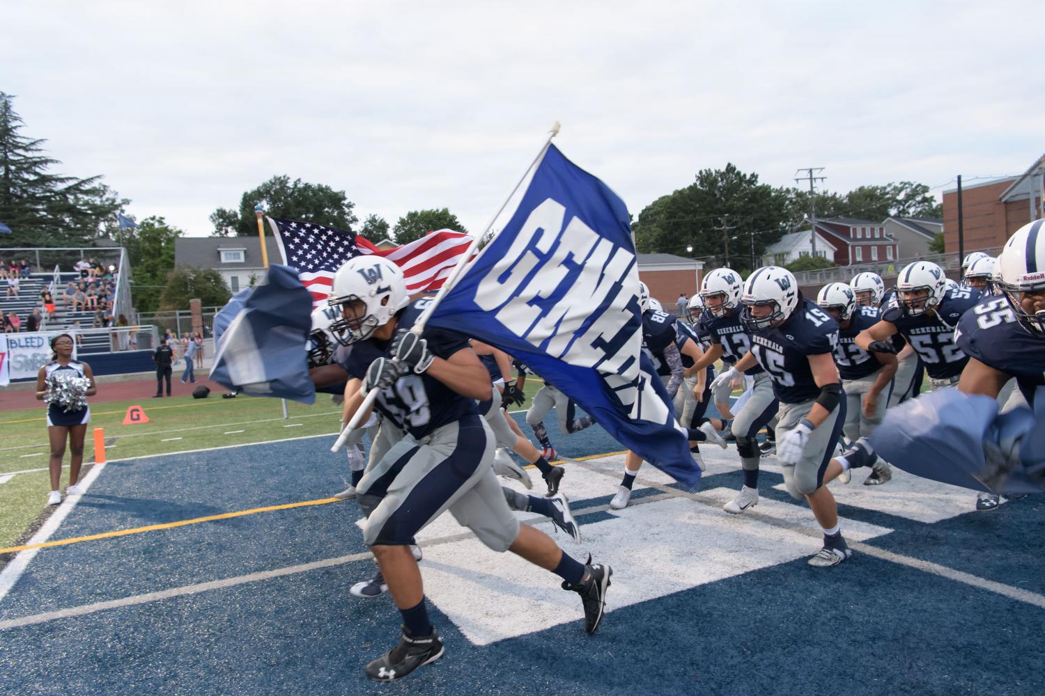 The varsity football team rushes the field at the fall pep rally. The team hopes to continue that success into the coming fall season with the addition of new players.