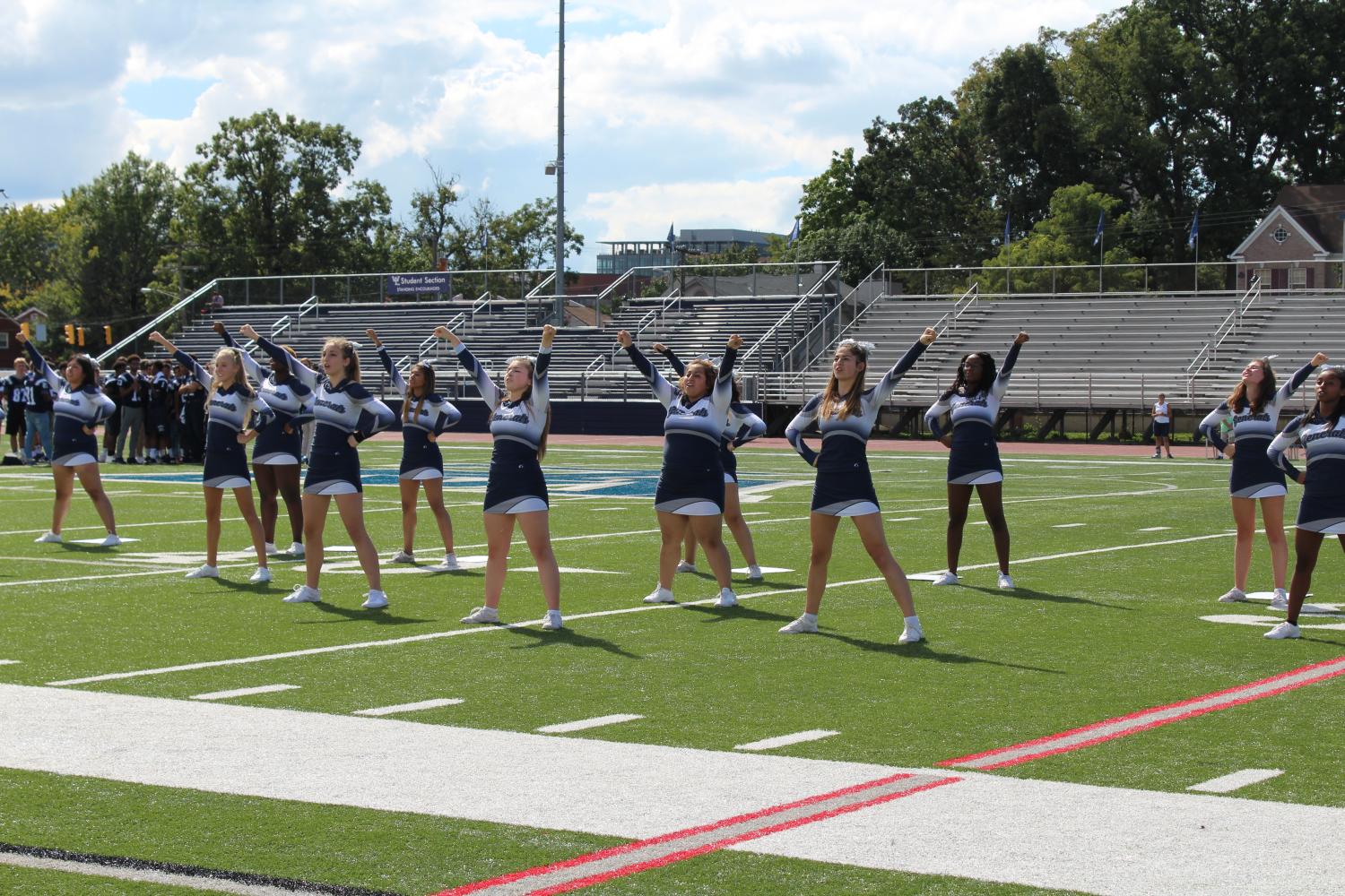 The varsity cheer team do a routine for the crowd at the pep rally