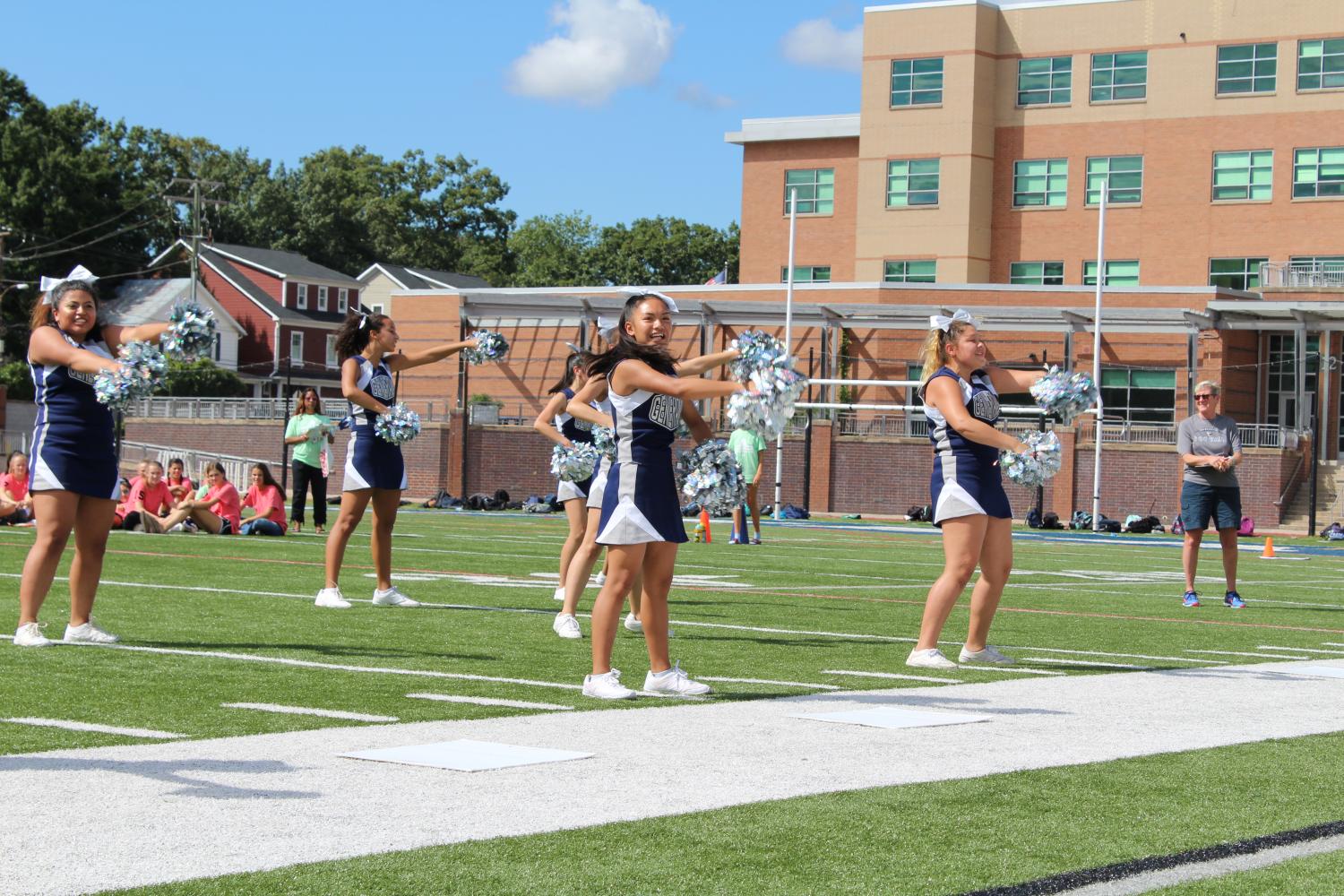 The JV cheer team performs a routine for the crowd at the pep rally