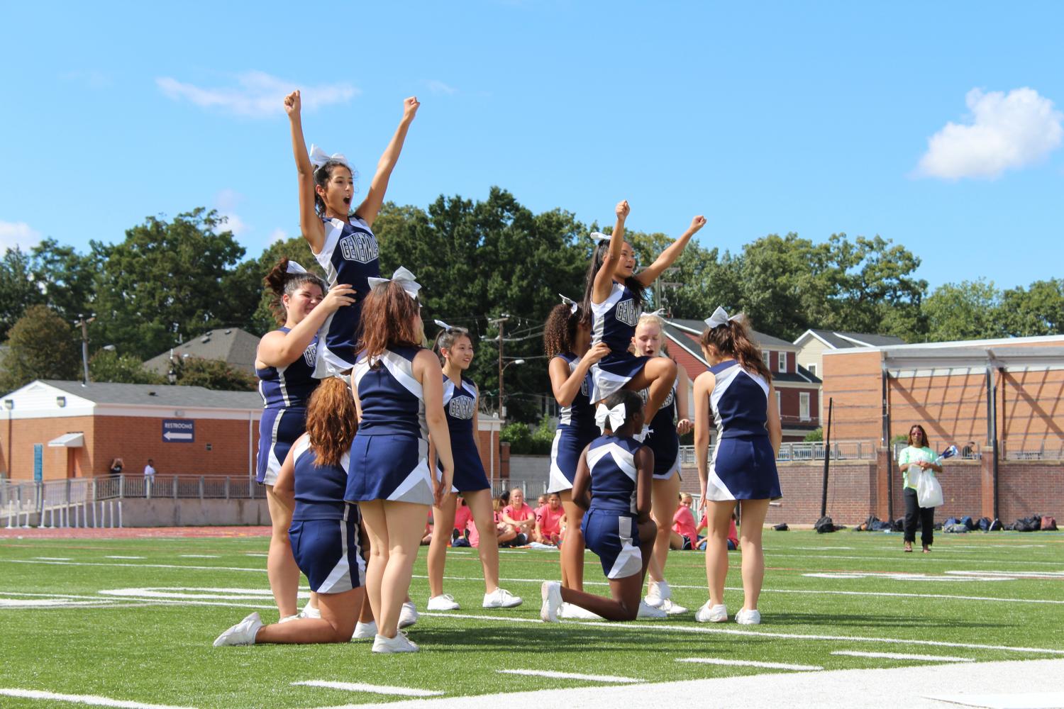 The JV cheer team gets ready to lift two of their members