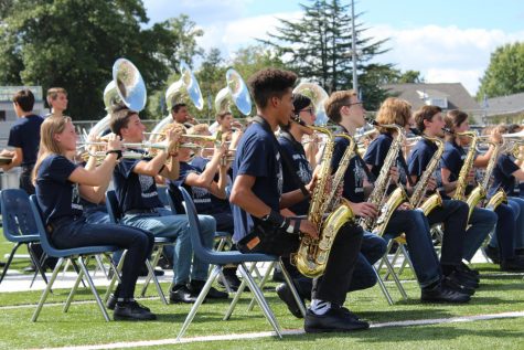 The trumpet players and saxophone players of the marching band are featured in the last song of the pep rally