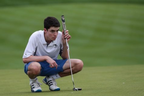 Senior Mac Mulock is in the zone as he find the best angle to line up the perfect shot.