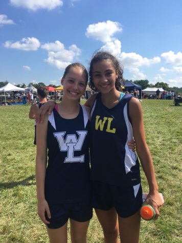 Sophomore Jeanie Laybourn (on the left) smiles beside her friend, sophomore Giulia Messa, after finishing a cross country race. Although she didn't meet her goal time last year, her New Years resolution is to continue to push herself when it comes to her running.