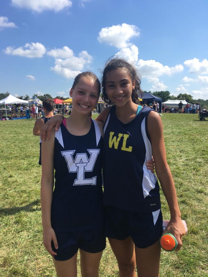 Sophomore Jeanie Laybourn (on the left) smiles beside her friend, sophomore Giulia Messa, after finishing a cross country race. Although she didnt meet her goal time last year, her New Years resolution is to continue to push herself when it comes to her running.