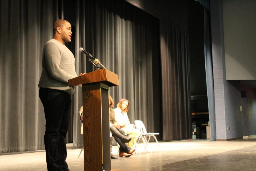 C. Thomas reads his poetry to students during the African American read in. 