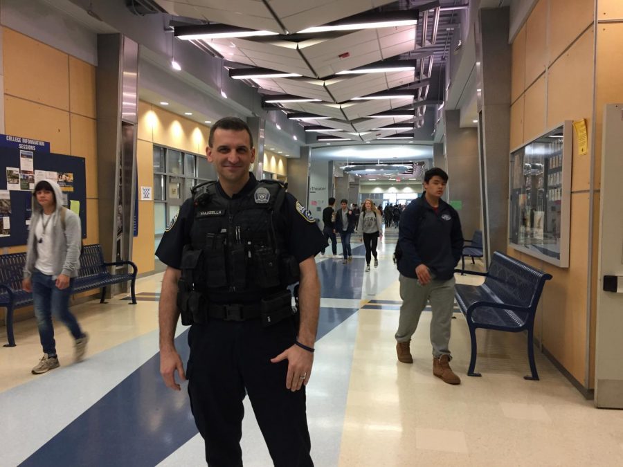 School SRO Marc Mazzella stands in the hallway between classes. Much of the responsibility of handling student crime is given to the SROs.