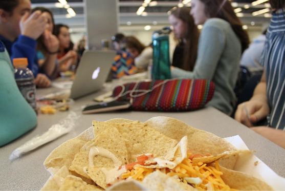 Students eat lunch in the school cafeteria. APS added the new Cafe Teria option this year in order to provide students with more healthy lunch choices.