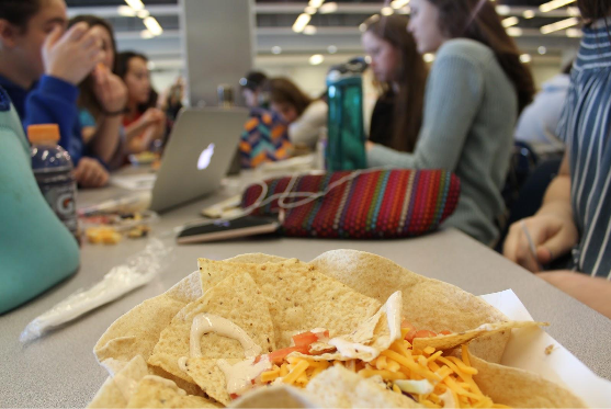 Students eat lunch in the school cafeteria. APS added the new Cafe Teria option this year in order to provide students with more healthy lunch choices. 