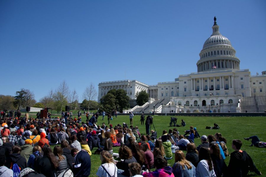 Students gather at the Capitol Building to watch a host of student speakers talk about gun control.