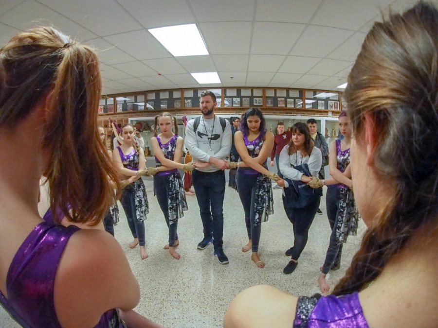 The Winter Guard team has a group huddle before a competition.