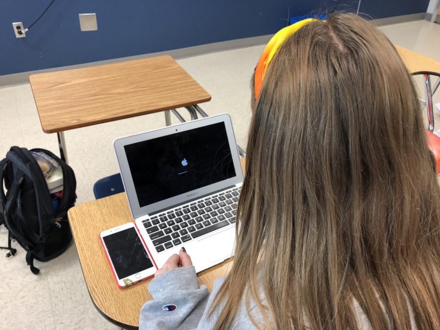 Junior Maddie Sims waits for a school laptop to restart. Earlier in the school year, the computers would frequently reboot themselves before the problem was fixed by APS.