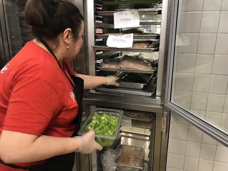 Ms. Nampha retrieves fresh peppers from one the many refrigerators in the cafeteria to prepare a sandwich for the students of Washington-Lee. 