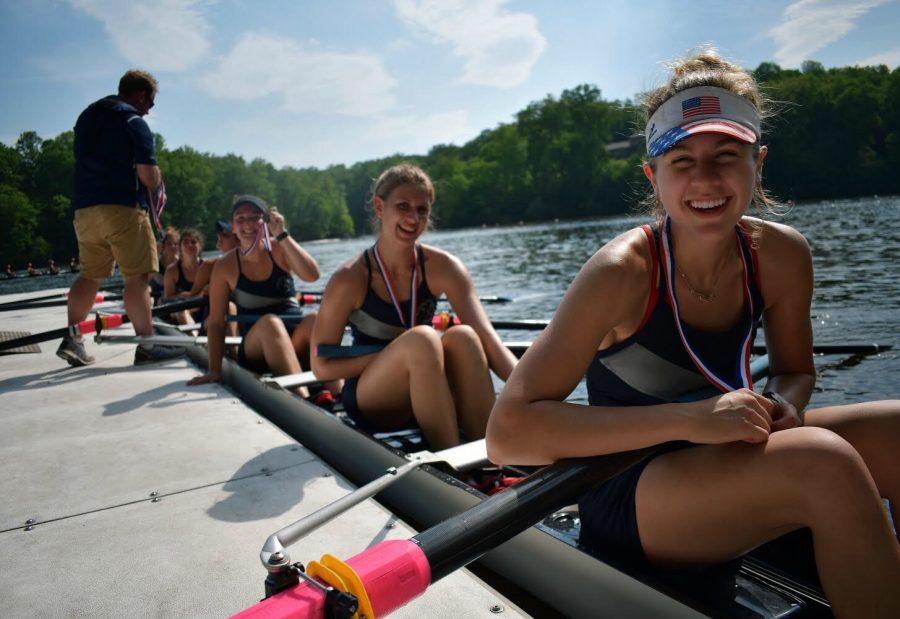 Junior Aidan Wrenn-Walz sits at the finish line dock with the first varsity boat, holding her second place medal at the States championship. The States championship is what rowers at the school spend most of the season preparing for. 