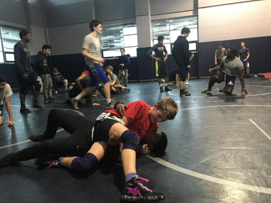 Freshman Henry Bedell performs a takedown on his teammate during wrestling practice at W-L. This is Bedell’s first year in varsity wrestling. 