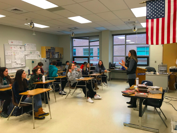 Ms. Larsen greeting her second period International Baccalaureate English Language and Literature class.