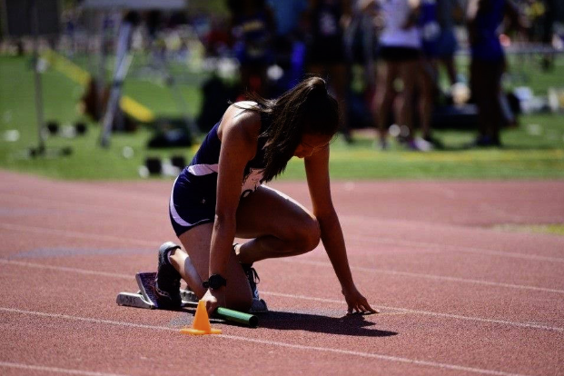 Lucy Brookover preparing to run a team relay. She recently ran at States with the track team.