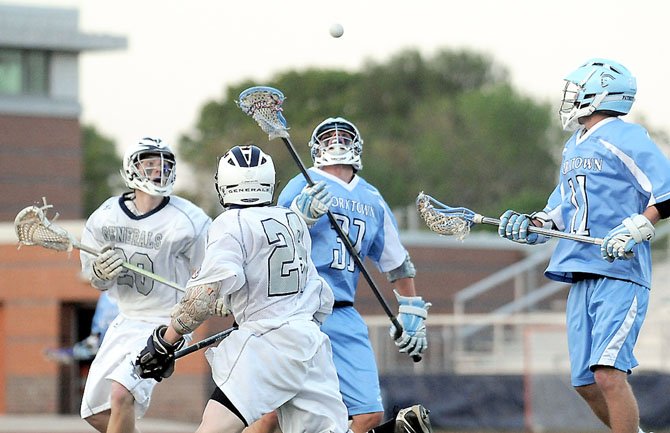 The Generals Varsity lacrosse team play the Yorktown patriots. The uniforms for boys lacrosse have more padding, as do their sticks. Photo Cred: Jeanie Laybourn and Lucas Codispoti