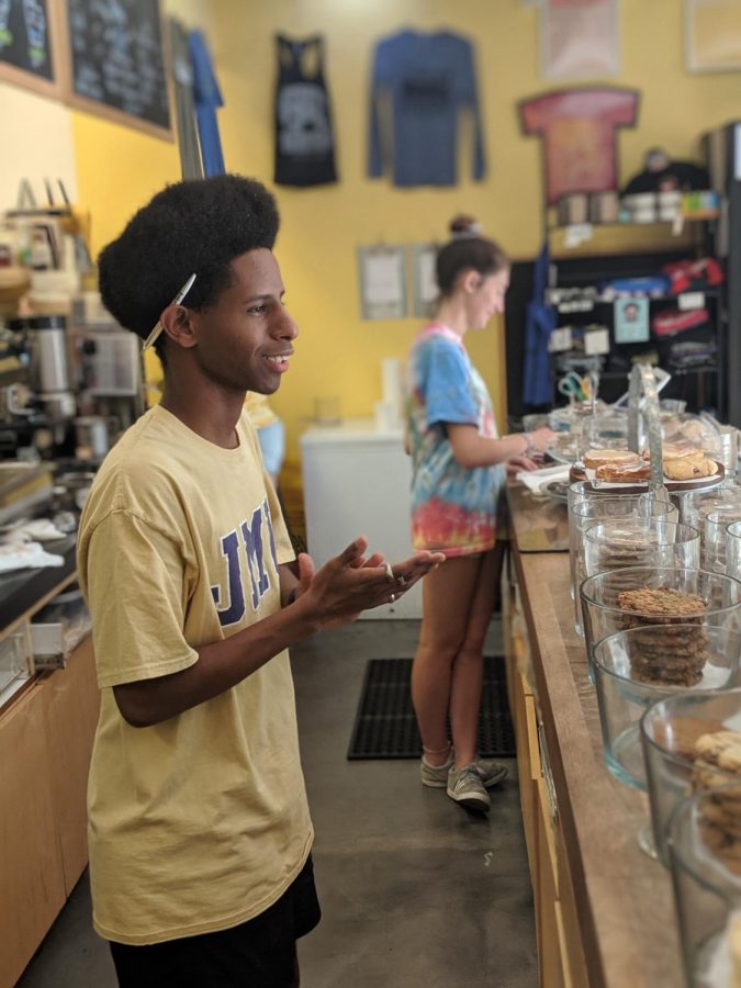 Washington-Liberty High School graduate Bemnet Negash greets one of Bakeshops customers. Bakeshop shits usually consist of serving customers and prepping materials such as bags for use. 