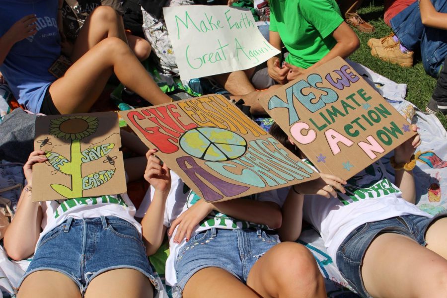 Students lay down with their homemade signs advocating for officials to acknowledge and try to better the issue.  