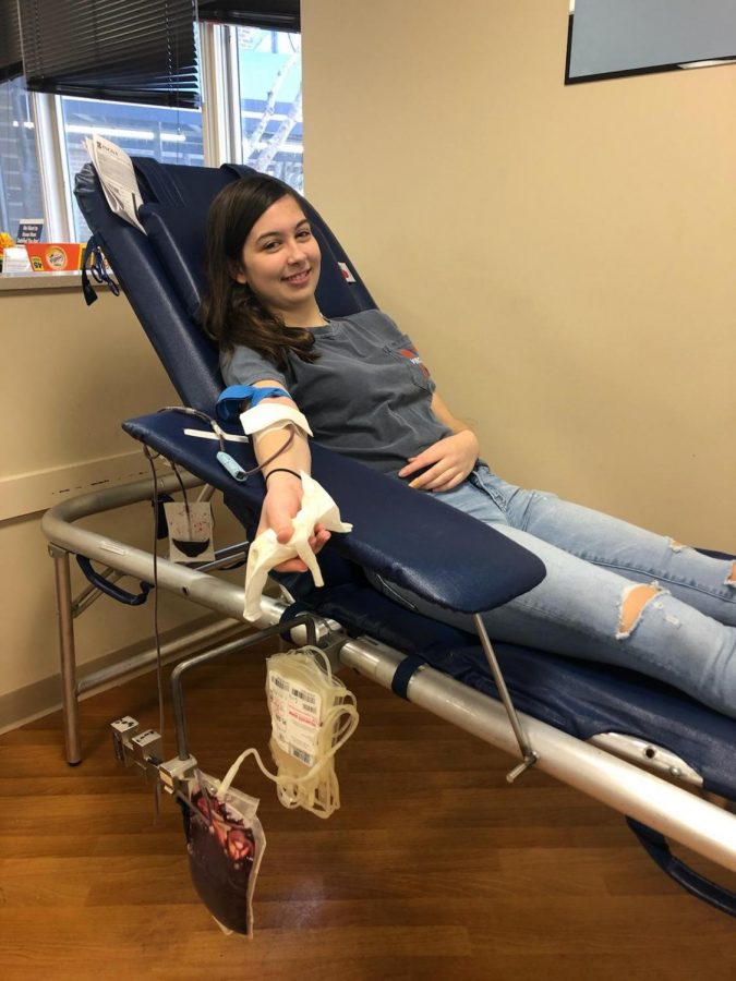 Senior Abby Presson, Editor in Chief of the Crossed Sabres, donates blood in the Inova bloodmobile. The hospital system is experiencing a critical shortage of blood due to the cancelation of events such as the Student Council Associations  annual blood drive.