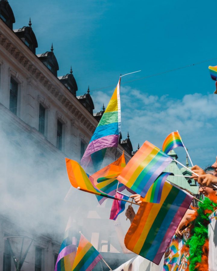 People hold rainbow flags at a pride parade. Last year, both Arlington and Alexandria received a perfect Municipal Equality Index score for LGBTQ inclusion.