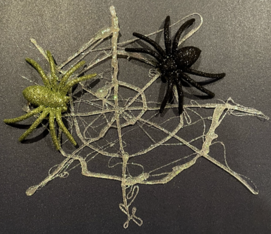 Hot Glue Spider Webs on Parchment Paper