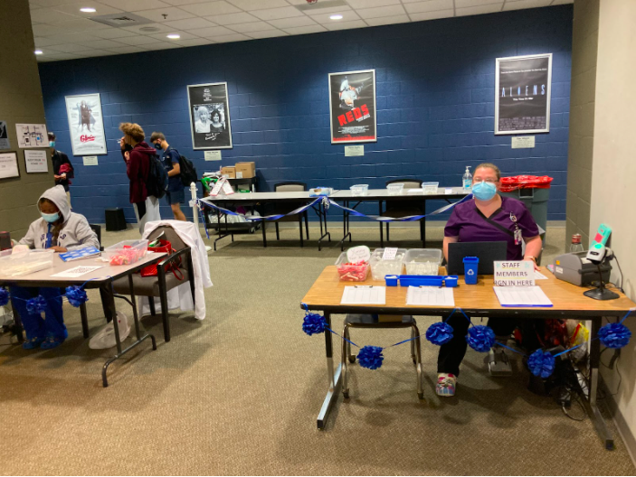 Students enter covid testing station outside the theater 