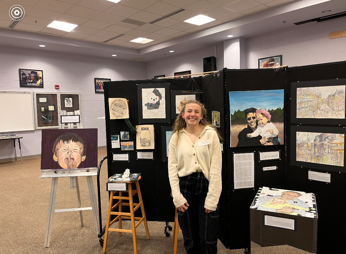 Senior Elizabeth Adams has taken IB Visual Arts and Art I and Art II at the school. She poses with her IB Visual Arts exhibition.

