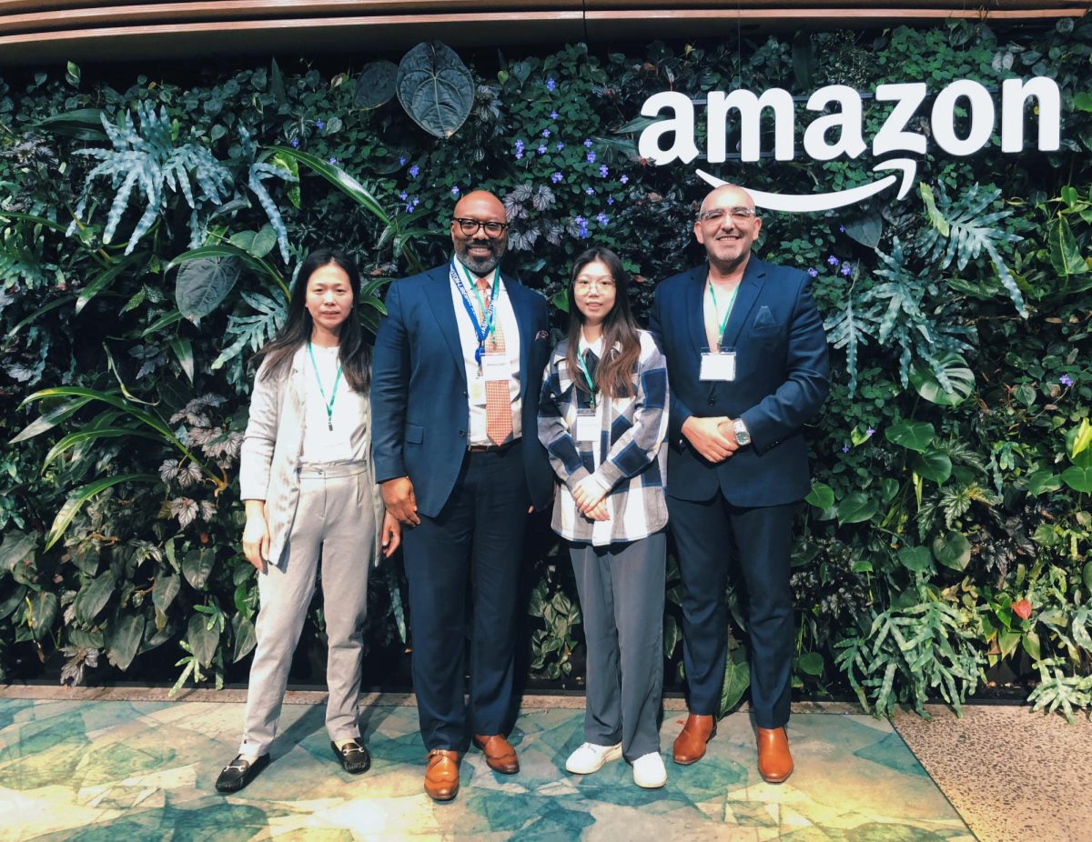 Qiaojing Huang won the Amazon scholarship this year. She poses with Mr. Hall and other officials.