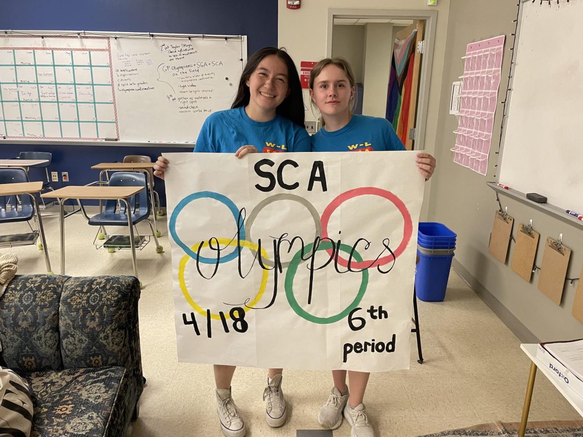 Taylor Walsh and Caroline South posing for a photo. They were setting up for the 2024 SCA Olympics. 