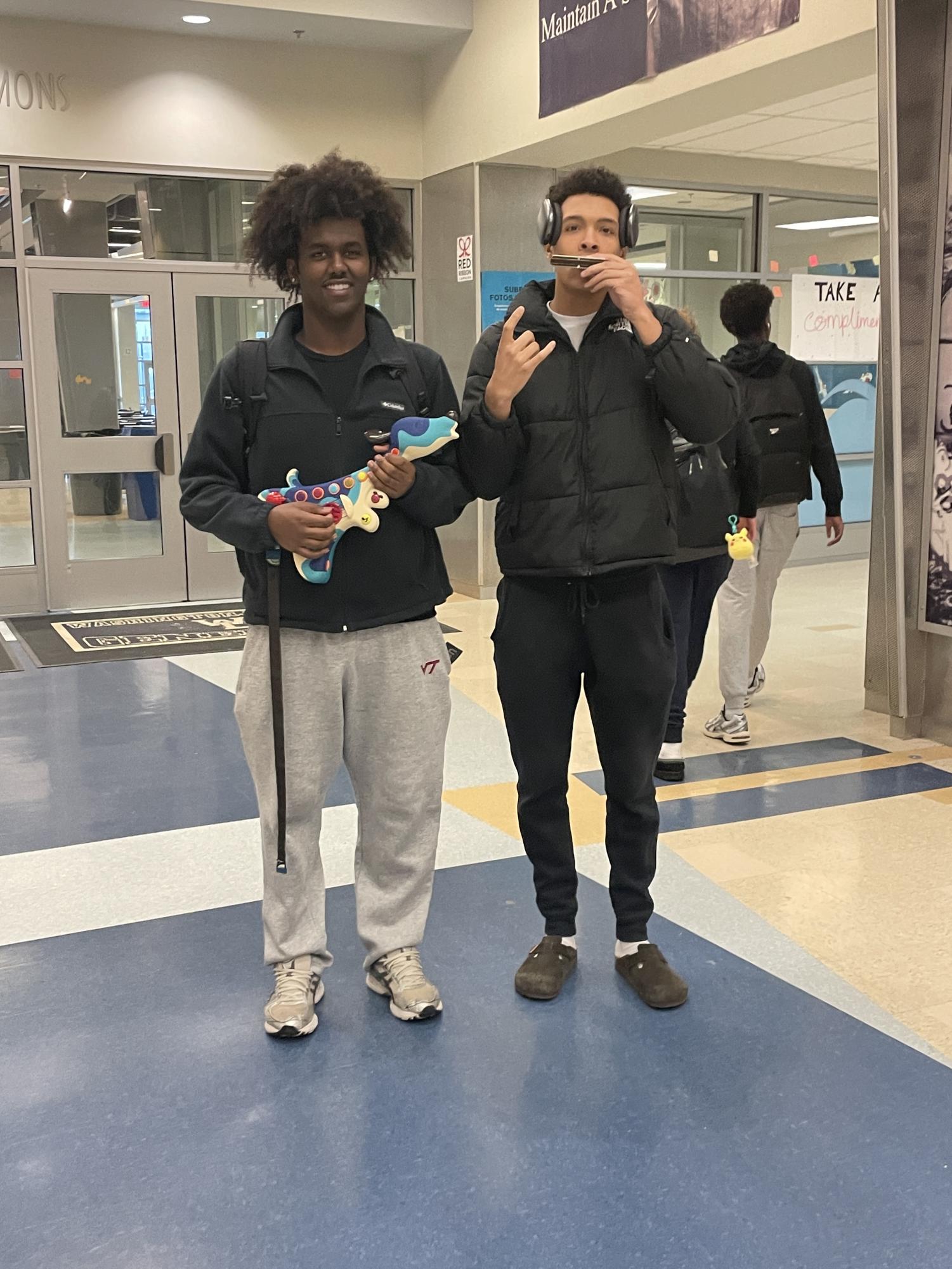 Seniors Caleb Arkebe and Tryston Griffin pose with their instruments. 