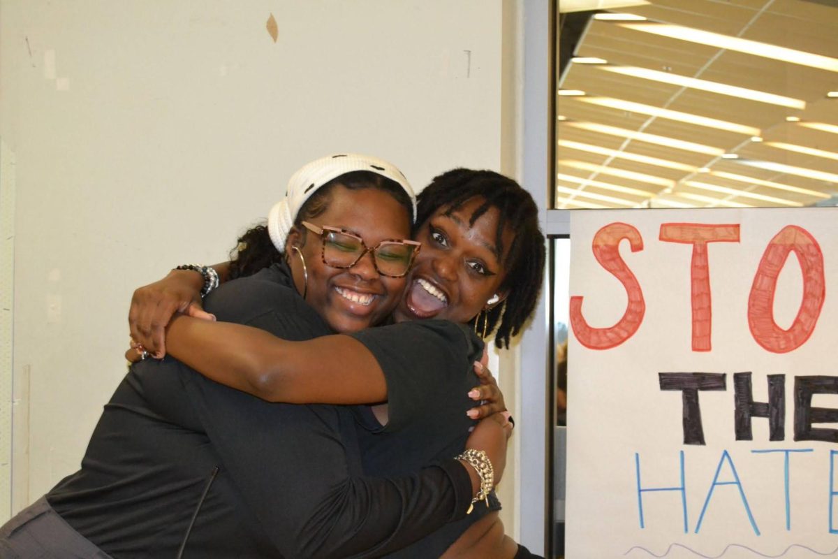 Mrs. Kay and Denisha Jones embrace in a hug. 
