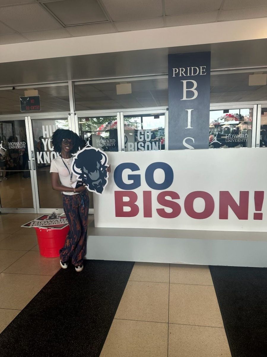 Senior Zara Musa at Howard University. She was posing with the mascot sign. 